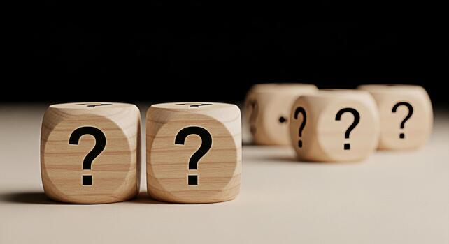Wooden dice displaying question marks in a studio setting symbolizing uncertainty and the need for solutions creating a mood of inquiry and problemsolving for business and personal challenges photo