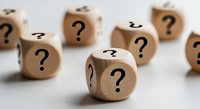 Wooden dice displaying question marks on a white surface symbolizing uncertainty and the need for answers in a challenging situation creating a mood of curiosity and problemsolving photo