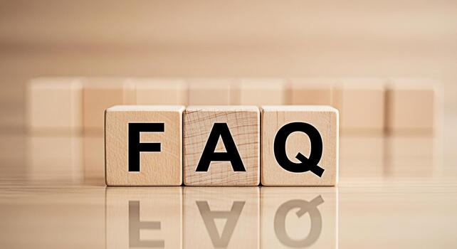 FAQ wooden blocks displaying information on a reflective surface representing frequently asked questions and providing clarity in a simple and accessible manner promoting understanding and guidance photo