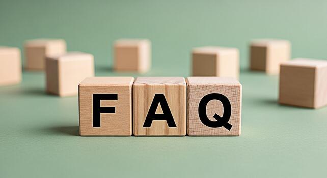 Wooden blocks displaying FAQ on a green surface representing frequently asked questions and information resources in a simple clear and accessible manner promoting knowledge and assistance photo
