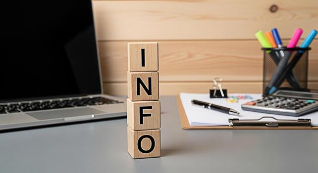 Wooden blocks spelling INFO on a modern office desk with a laptop calculator and stationery conveying a message of information knowledge and data analysis in a professional workspace photo