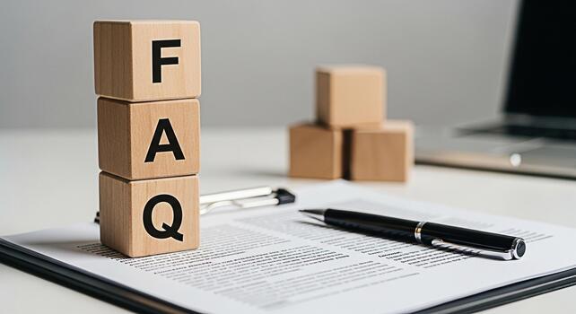 Wooden blocks displaying FAQ on a document with a pen in a bright office setting representing frequently asked questions information access and customer support for business and online services photo