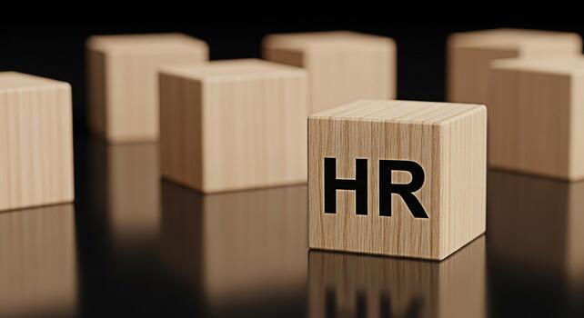 Wooden blocks displaying HR on a reflective surface representing human resources management and organizational structure in a corporate environment conveying a sense of professionalism and strategic p photo
