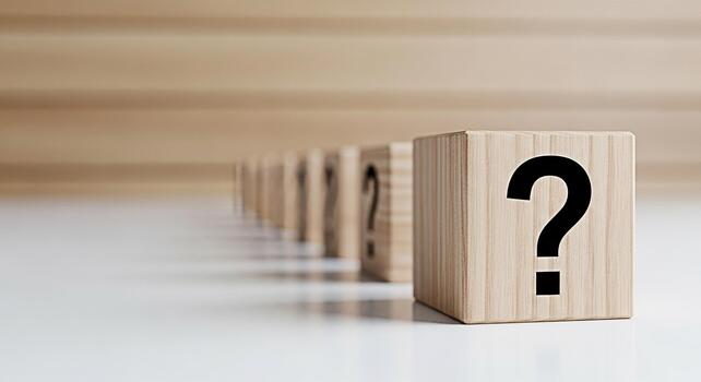 Wooden blocks displaying question marks on a white surface representing uncertainty and the search for answers in a minimalist and clean environment evoking curiosity and problemsolving photo