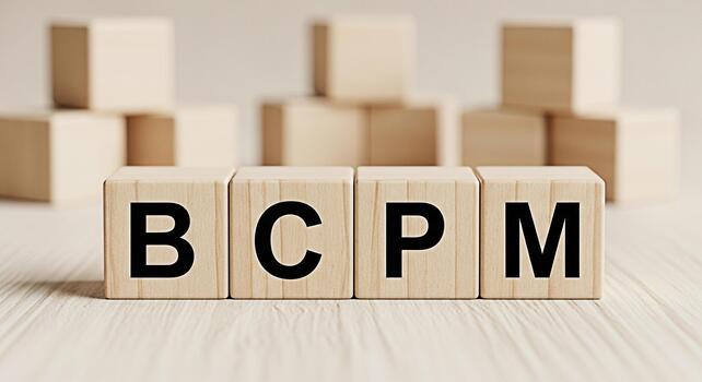 Wooden blocks displaying BCPM on a bright wooden surface representing business continuity planning and management with a focus on resilience and strategic foresight in a corporate environment photo