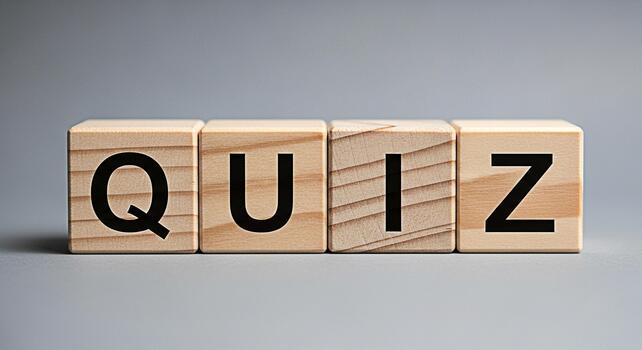 Wooden blocks spelling QUIZ on a gray surface representing a test of knowledge and skills creating an atmosphere of challenge and intellectual stimulation in an educational setting photo