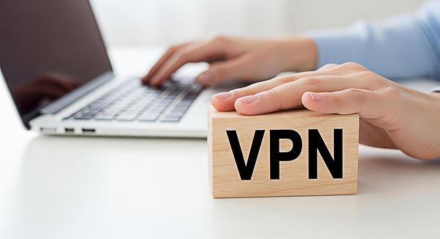 Person using a laptop computer with a VPN wooden block on a white desk emphasizing secure online browsing and data protection in a modern workspace conveying a sense of digital safety and privacy photo