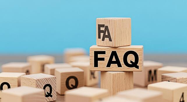 Wooden blocks displaying FAQ stacked against a blue background representing frequently asked questions and providing helpful information in a clear and concise manner promoting understanding and clari photo