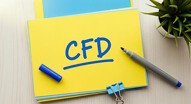 Bright yellow notepad displaying CFD on a wooden desk with a marker paperclip and potted plant representing computational fluid dynamics in a modern and organized workspace photo