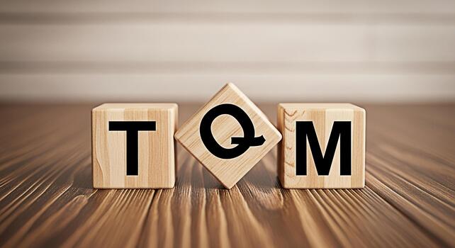 Wooden blocks displaying TQM on a wooden surface representing Total Quality Management in a business setting conveying a message of efficiency excellence and continuous improvement photo