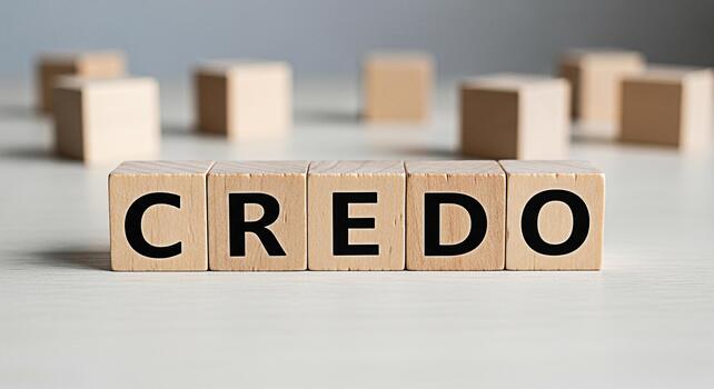 Wooden blocks spelling CREDO on a white surface representing a belief system guiding principles and core values in a minimalist and clean setting conveying trust faith and conviction photo