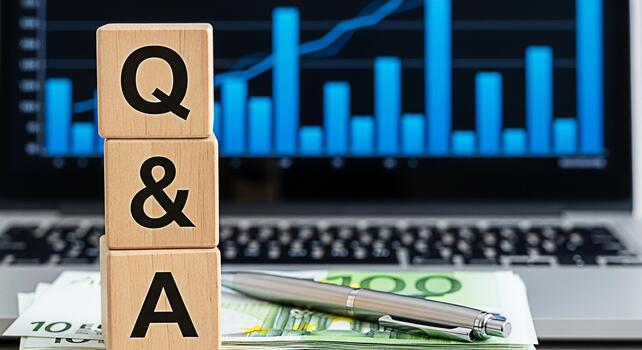 Wooden blocks displaying QA on a desk with a laptop showing financial charts symbolizing business consultation and knowledge sharing in a corporate environment fostering clarity and informed decisionm photo