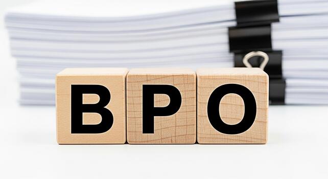 Wooden blocks displaying BPO in a bright office setting representing business process outsourcing and efficient document management for streamlined operations and improved organizational workflow photo