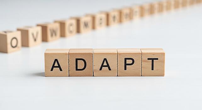 Wooden blocks spelling ADAPT on a white surface symbolizing flexibility and resilience in a changing environment conveying a message of business agility and the importance of adapting to new challenge photo