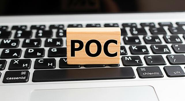 Wooden block displaying POC resting on a laptop keyboard in a bright office setting symbolizing proof of concept innovation and technological advancement in business and software development photo