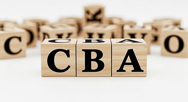 Wooden alphabet blocks spelling CBA on a white surface representing learning and early childhood education in a clean minimalist studio setting conveying a sense of simplicity and foundational knowled photo
