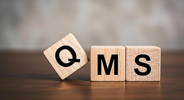 Wooden blocks spelling QMS on a wooden surface conveying a message about quality management systems in a business environment promoting efficiency and standardization for business success photo