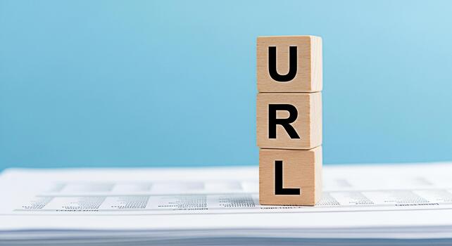 Wooden blocks spelling URL stacked on documents against a blue background representing website addresses internet navigation and online resources for business and technology concepts photo