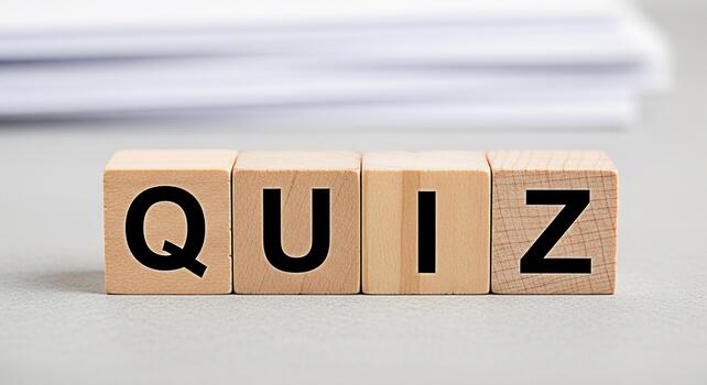 Wooden blocks spelling QUIZ on a neutral surface representing knowledge assessment and intellectual challenge in an educational setting fostering curiosity and engagement photo