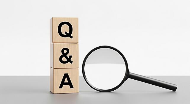 Wooden blocks displaying Q A being examined with a magnifying glass on a gray surface against a white background symbolizing inquiry problemsolving and the search for answers photo