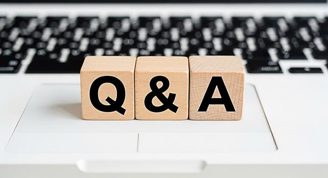 Wooden blocks displaying QA on a laptop keyboard representing questions and answers knowledge sharing and problemsolving in a modern digital environment fostering clarity and understanding photo