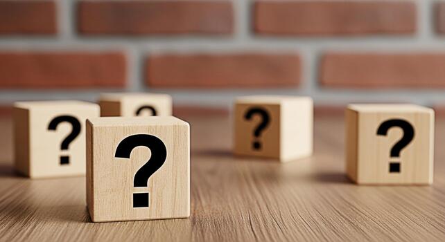 Wooden blocks displaying question marks on a wooden surface against a brick wall symbolizing uncertainty and the search for answers in business education and personal life creating a sense of mystery photo