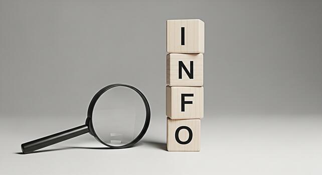 Magnifying glass examining wooden blocks spelling INFO in a bright studio setting symbolizing investigation research and the pursuit of knowledge and data analysis for business and educational purpose photo