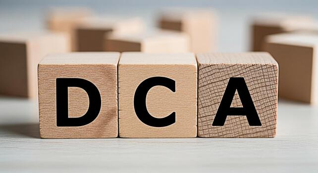 Wooden blocks displaying DCA on a neutral surface representing financial planning and investment strategies for a secure financial future with dollar cost averaging photo
