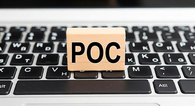 Wooden block displaying POC on a laptop keyboard symbolizing proof of concept in a modern office environment representing innovation and technological advancement in project development photo