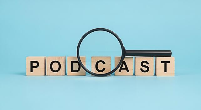 Podcast concept with wooden blocks spelling the word podcast and a magnifying glass on a blue background representing the search and discovery of audio content creating a modern and informative mood photo