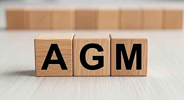 Wooden blocks displaying AGM on a bright surface symbolizing an Annual General Meeting fostering transparency and corporate governance in a collaborative and structured environment photo
