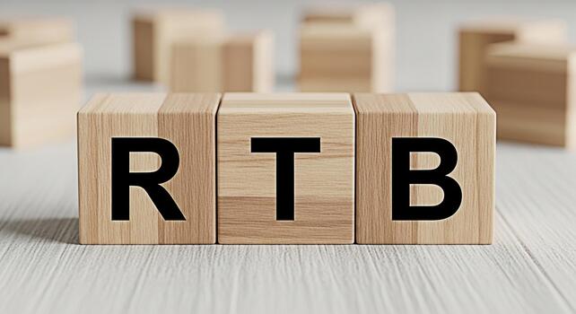 Wooden blocks displaying RTB on a white wooden surface representing realtime bidding in a modern minimalist setting conveying a sense of precision and technological advancement in digital advertising photo