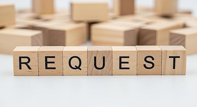Wooden blocks spelling REQUEST on a white surface surrounded by other blocks representing a formal appeal or application conveying a sense of demand and expectation in a business context photo