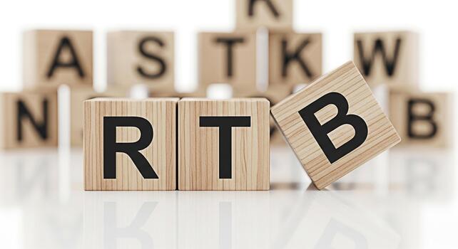 Wooden blocks displaying letters on a white surface spelling out RTB conveying a message of learning and education in a bright and minimalist setting perfect for educational resources and creative pro photo