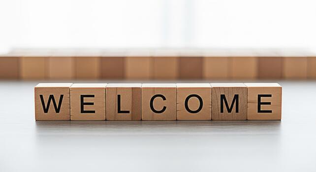 Wooden blocks spelling Welcome on a table inviting and friendly conveying a sense of hospitality and openness perfect for greeting visitors or new members in a warm and inviting setting photo