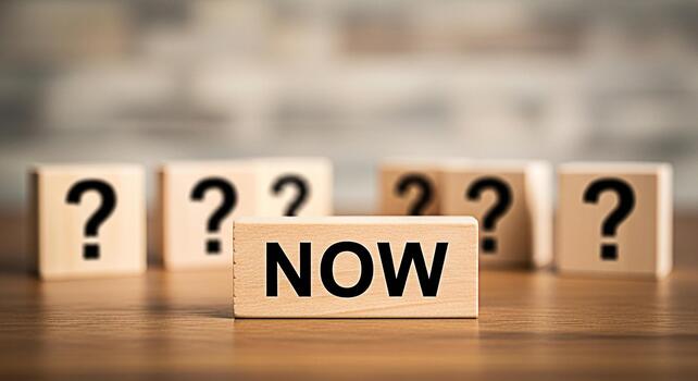 Wooden blocks displaying NOW among question marks on a wooden surface symbolizing decisionmaking and taking action in a timely manner creating a sense of urgency and opportunity in a blurred backgroun photo