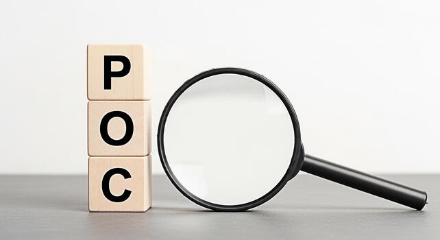 Magnifying glass inspecting wooden blocks spelling POC on a gray surface against a white background symbolizing proof of concept and the importance of thorough examination and validation in business a photo