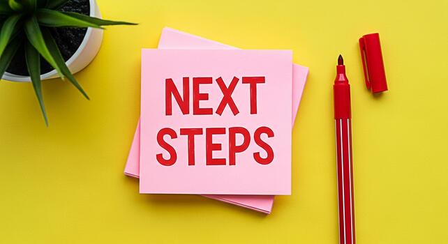 Bright yellow desktop featuring pink sticky notes displaying Next Steps with a red marker and potted plant symbolizing planning and forwardthinking in a vibrant optimistic setting photo