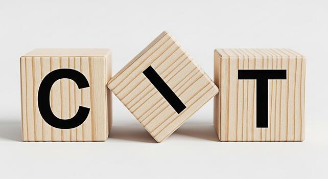 Wooden blocks displaying the letters CIT on a white surface representing concepts like coding information technology or career opportunities in a minimalist and clean studio environment photo