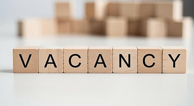 Wooden blocks spelling VACANCY on a white surface representing job openings and recruitment creating a sense of opportunity and new beginnings in a professional and modern setting photo