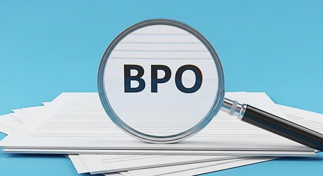 Magnifying glass focusing on BPO acronym on a stack of documents against a blue background symbolizing business process optimization and strategic outsourcing for efficiency and growth photo