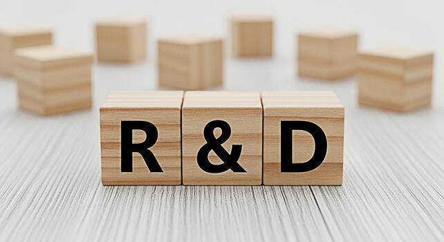 Wooden blocks displaying R D on a white wooden surface symbolizing research and development in a clean minimalist setting conveying innovation progress and strategic planning for business growth photo