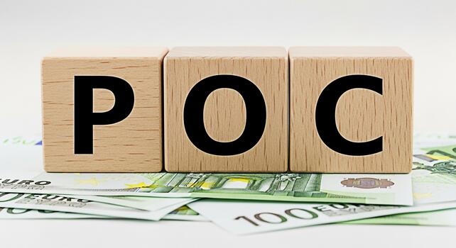 Wooden blocks displaying POC on a pile of Euro banknotes representing Proof of Concept in a financial setting emphasizing business validation and investment feasibility with a clean minimalist aesthet photo