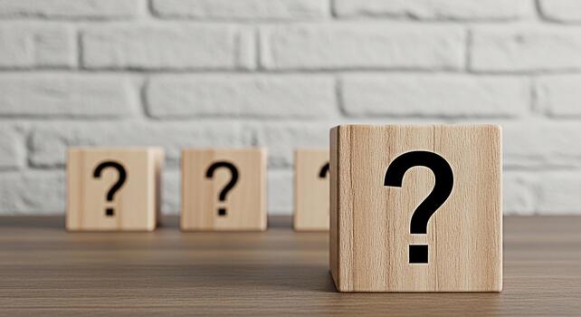 Wooden blocks displaying question marks on a wooden surface against a white brick wall symbolizing uncertainty inquiry and the search for answers in a minimalist and thoughtprovoking composition photo