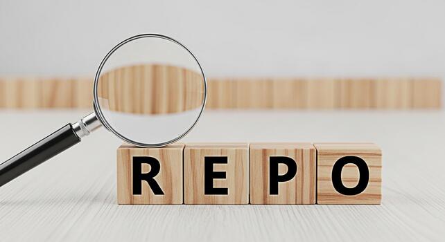 Magnifying glass inspecting wooden blocks spelling REPO on a bright white table representing financial analysis and the concept of repossession with a serious and focused mood photo
