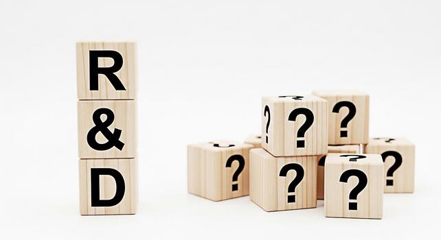 Wooden blocks displaying RD and question marks symbolizing research and development challenges and uncertainties in a bright minimalist setting conveying a sense of inquiry and problemsolving photo