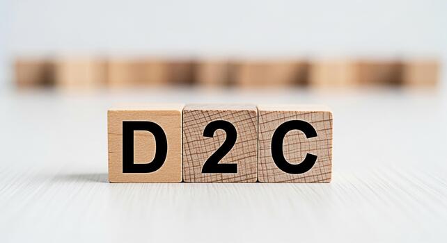 Wooden blocks displaying D2C on a bright surface representing a direct to consumer business model conveying a modern and innovative approach to retail and ecommerce strategies photo