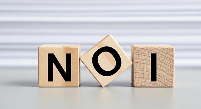 Wooden blocks spelling NOI on a gray surface conveying a message of decision and choice in a clean minimalist setting creating a sense of clarity and directness suitable for business or personal devel photo