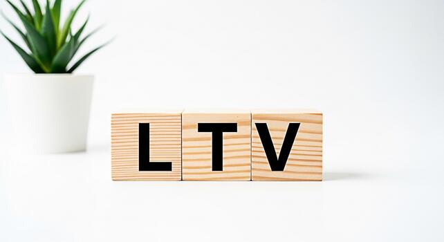 Wooden blocks displaying LTV on a white surface symbolizing customer lifetime value in a clean minimalist setting conveying a message of business growth and financial planning photo