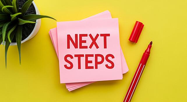 Pink sticky notes displaying Next Steps on a vibrant yellow desk with a red marker and a potted plant symbolizing planning and progress in a bright optimistic environment photo